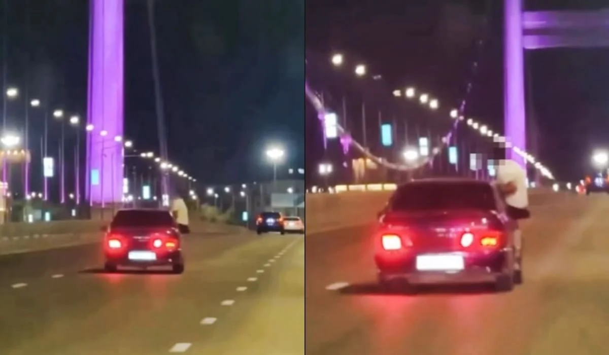 Видео опасной поездки на мосту в Семее: пассажир ехал, сидя на двери автомобиля